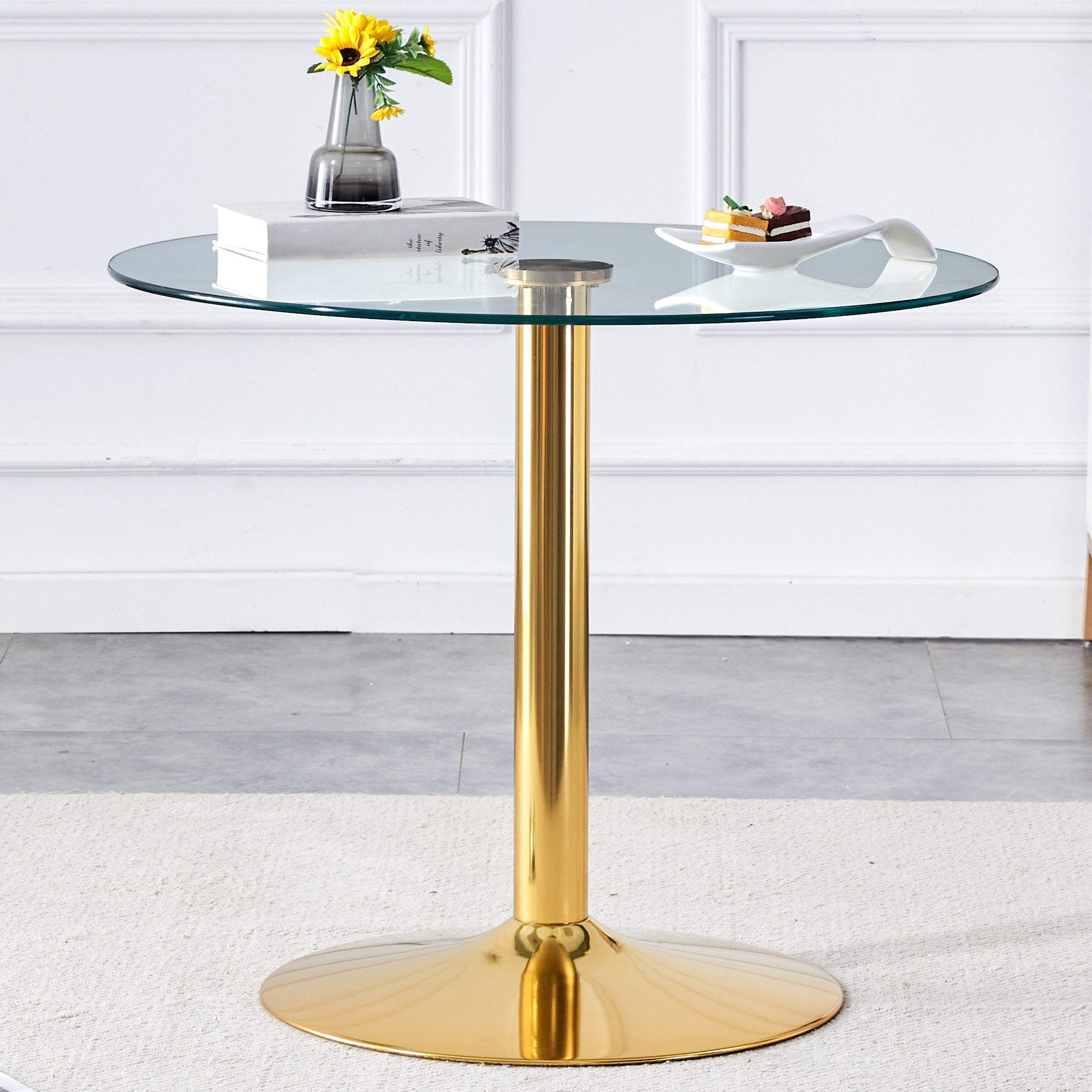 A 35-inch diameter glass top and a modern, minimalist round dining table with gold metal legs. Ideal for dining rooms, living rooms and meeting rooms.W1151P263755