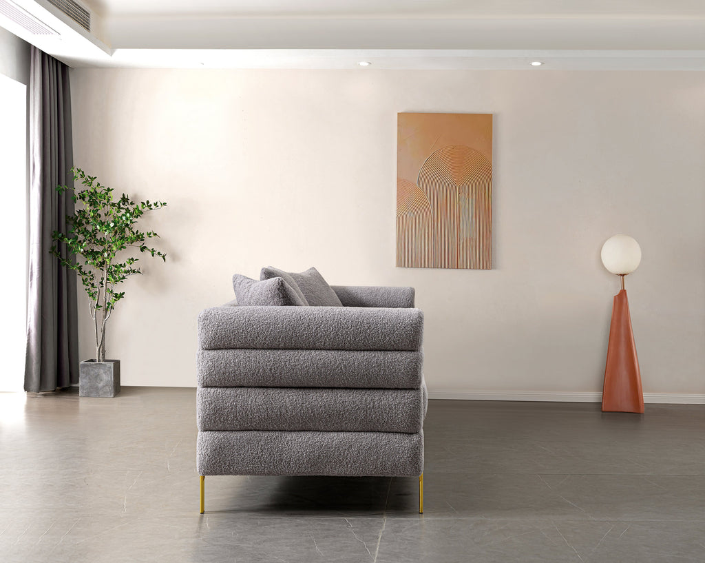 Luxurious and comfortable upholstered sofa with golden legs and pillows for living room and reception area