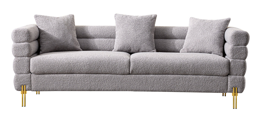Luxurious and comfortable upholstered sofa with golden legs and pillows for living room and reception area