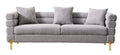 Luxurious and comfortable upholstered sofa with golden legs and pillows for living room and reception area