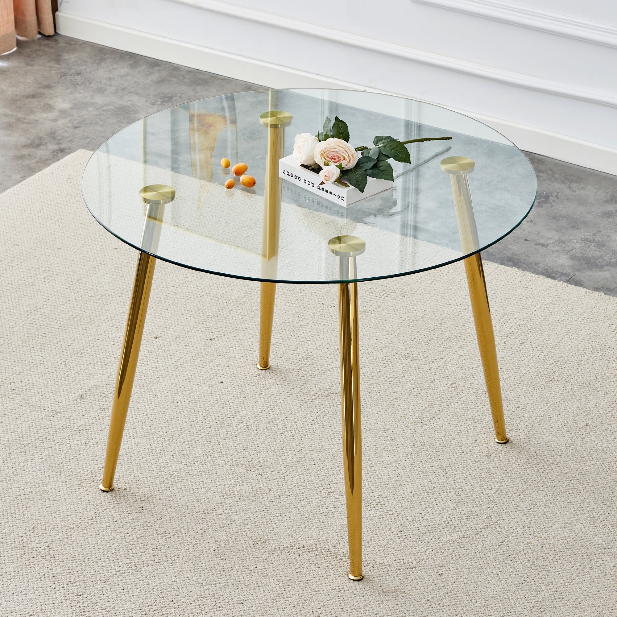 A glass tabletop with a diameter of 40 inches and a modern minimalist circular dining table with gold plated metal legs. 40 '* 40' * 30 ' DT-1164.W1151S00375
