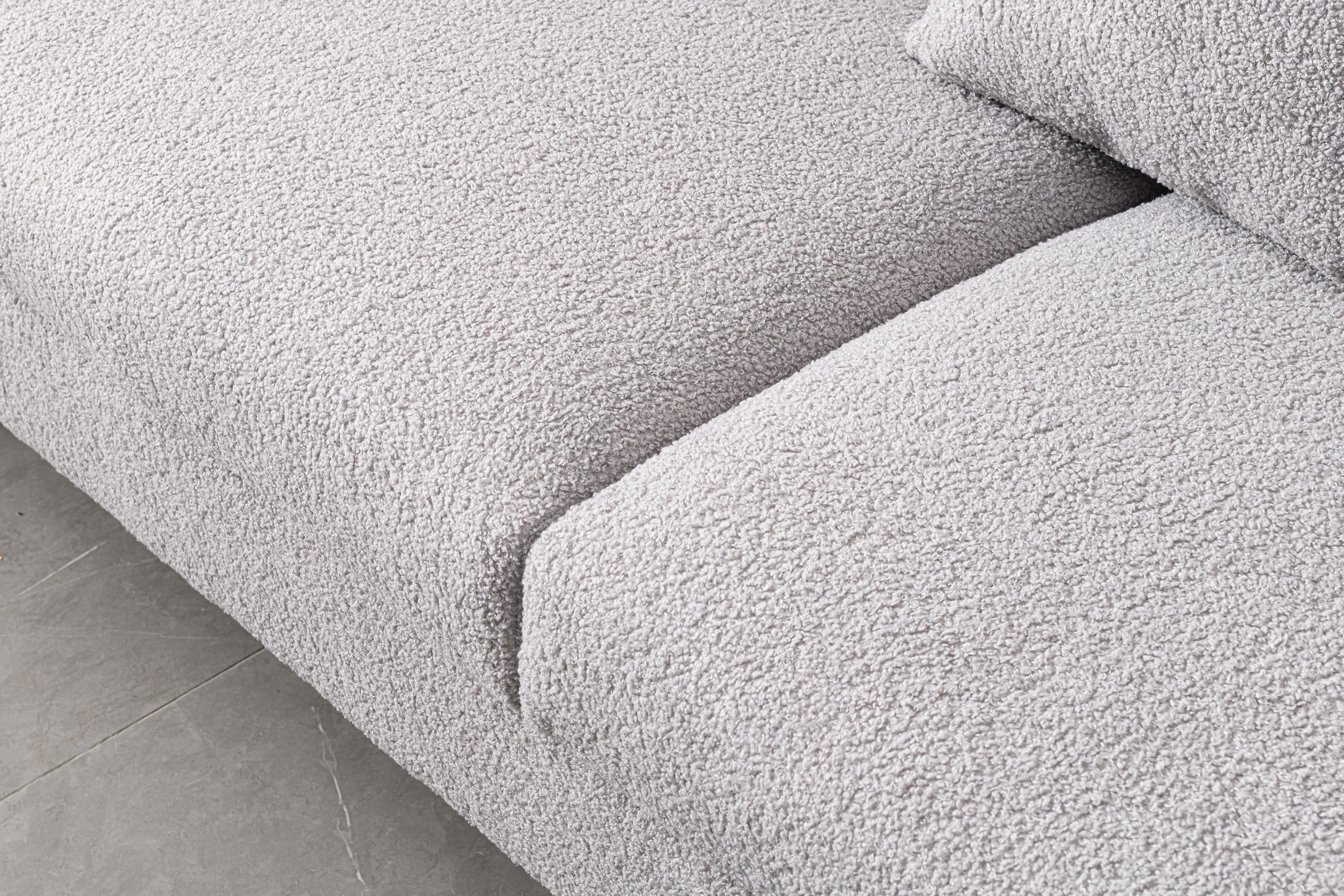 Luxurious and comfortable upholstered sofa with golden legs and pillows for living room and reception area