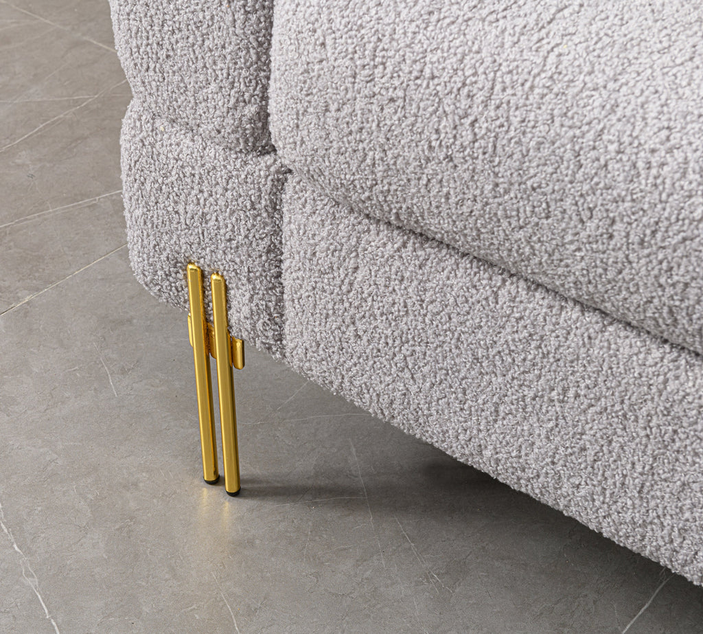 Luxurious and comfortable upholstered sofa with golden legs and pillows for living room and reception area